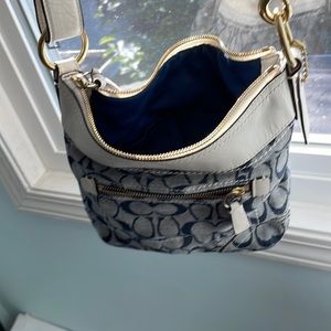 Coach bag with white leather handle and denim monogram and outside pocket